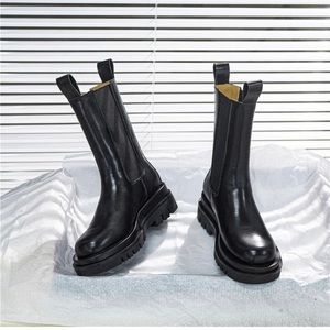 black leather and lug sole mid calf chelsea utility boot